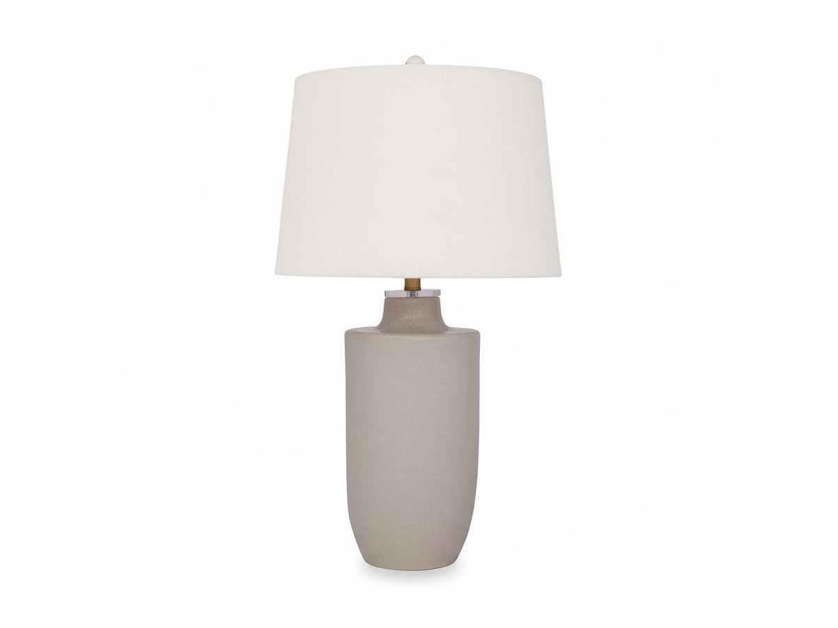 The Cylener table lamp with a beige ceramic base and white shade on a white background.