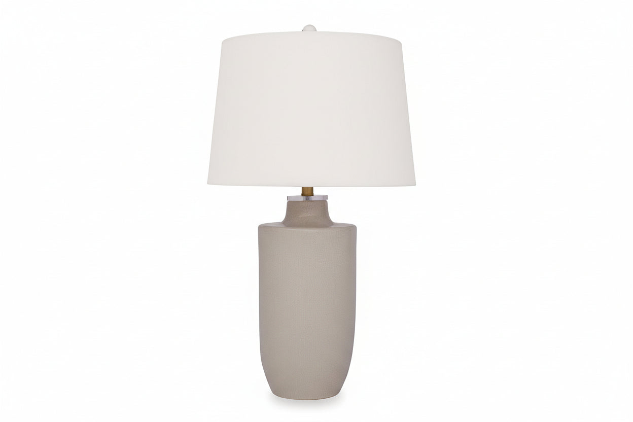 The Cylener table lamp with a beige ceramic base and white shade on a white background.