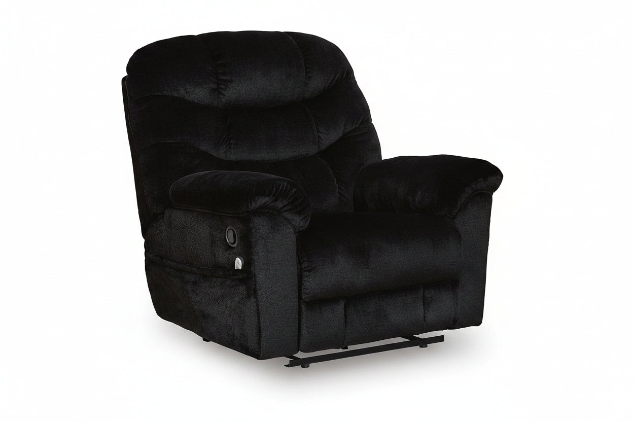 Black plush recliner chair with padded headrest, wide armrests, and a rocking base, shown on a clean white background.