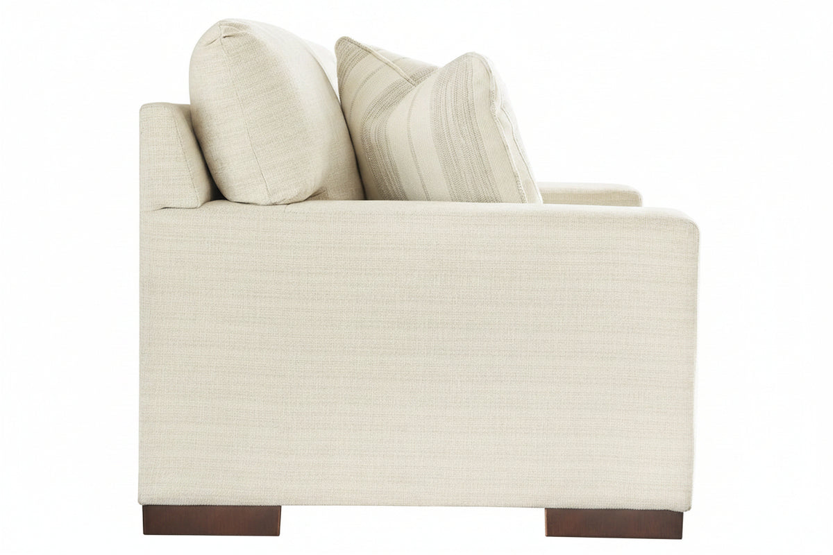 Beige armchair with two pillows on a white background