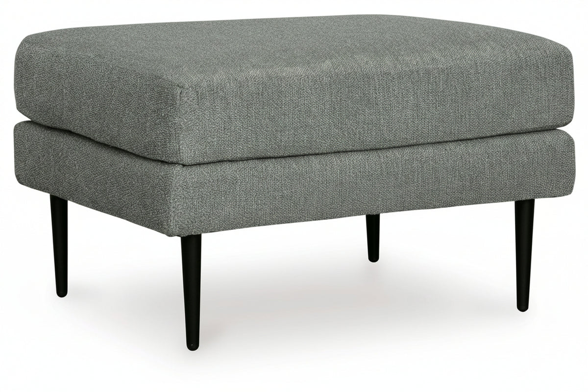Gray upholstered ottoman with black legs on a white background