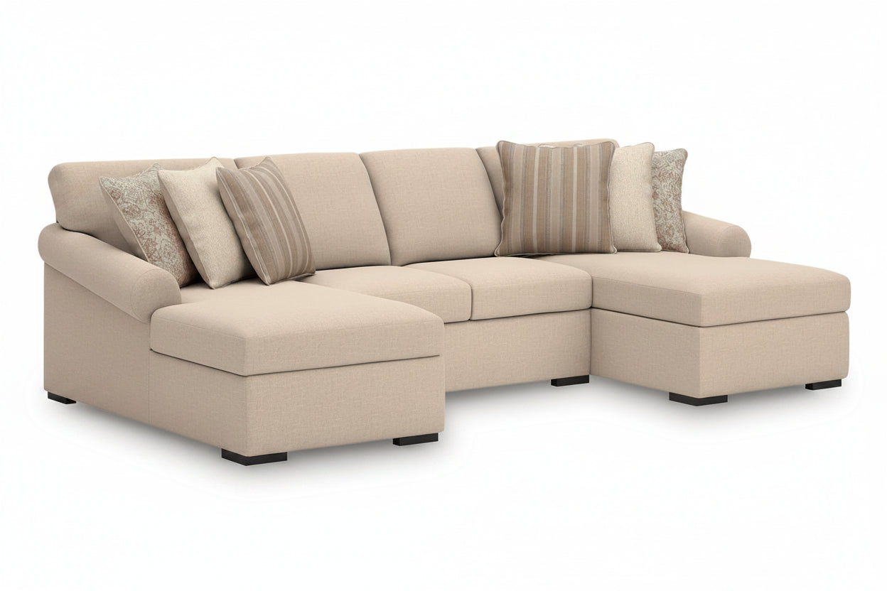 Beige sectional sofa with patterned cushions on a white background
