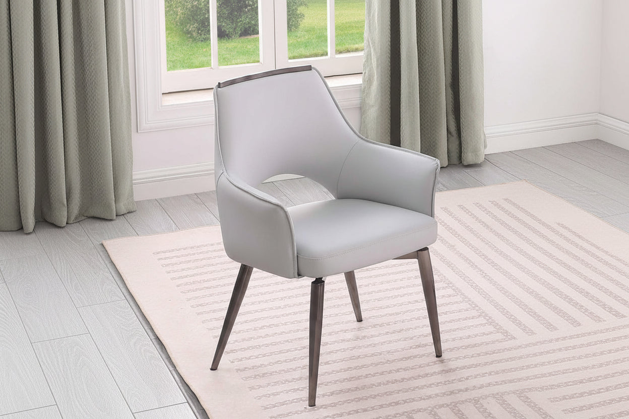 Devan gray armchair with wooden legs in a room with large windows and curtains.