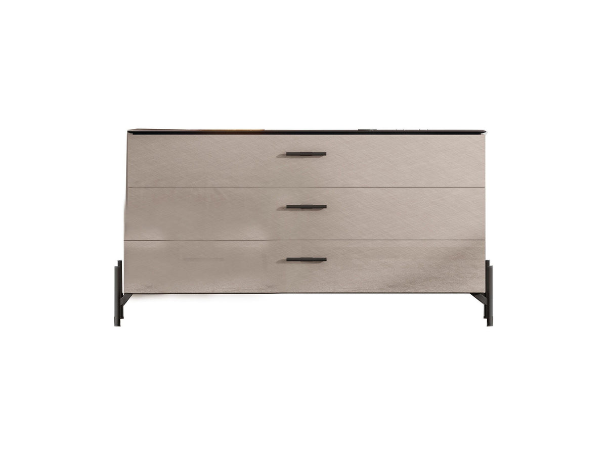 A modern three-drawer dresser with a light beige wood-grain finish, black metal legs, and slim black drawer pulls, shown against a plain white background.