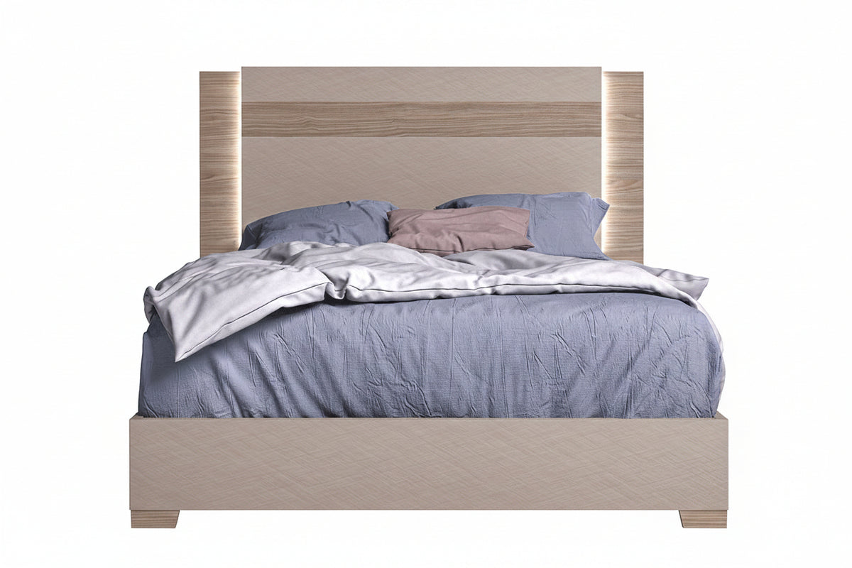 Bed with wooden headboard and bedding on a white background