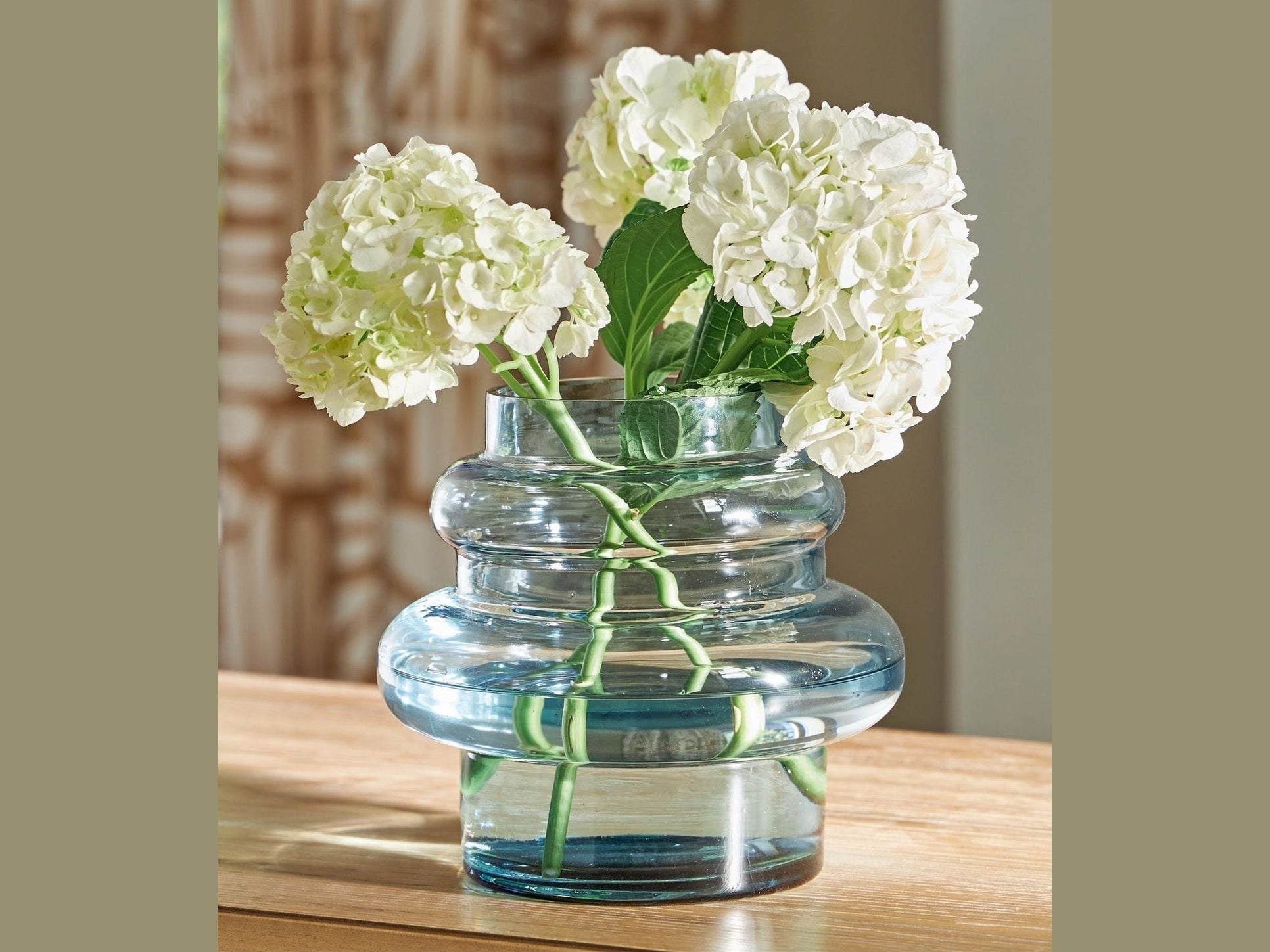 Vallmen clear glass vase with white flowers on a wooden surface