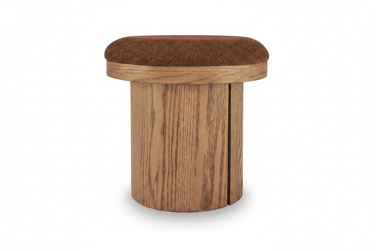 A modern cylindrical ottoman stool with a round brown upholstered seat cushion and a light brown wood-grain base, shown on a white background.