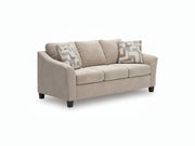Beige sofa with patterned cushions on a white background