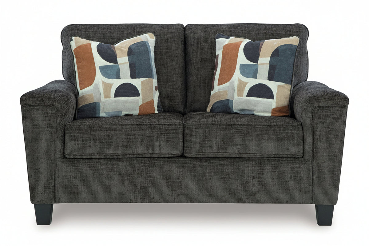 Gray sofa with two patterned cushions on a white background