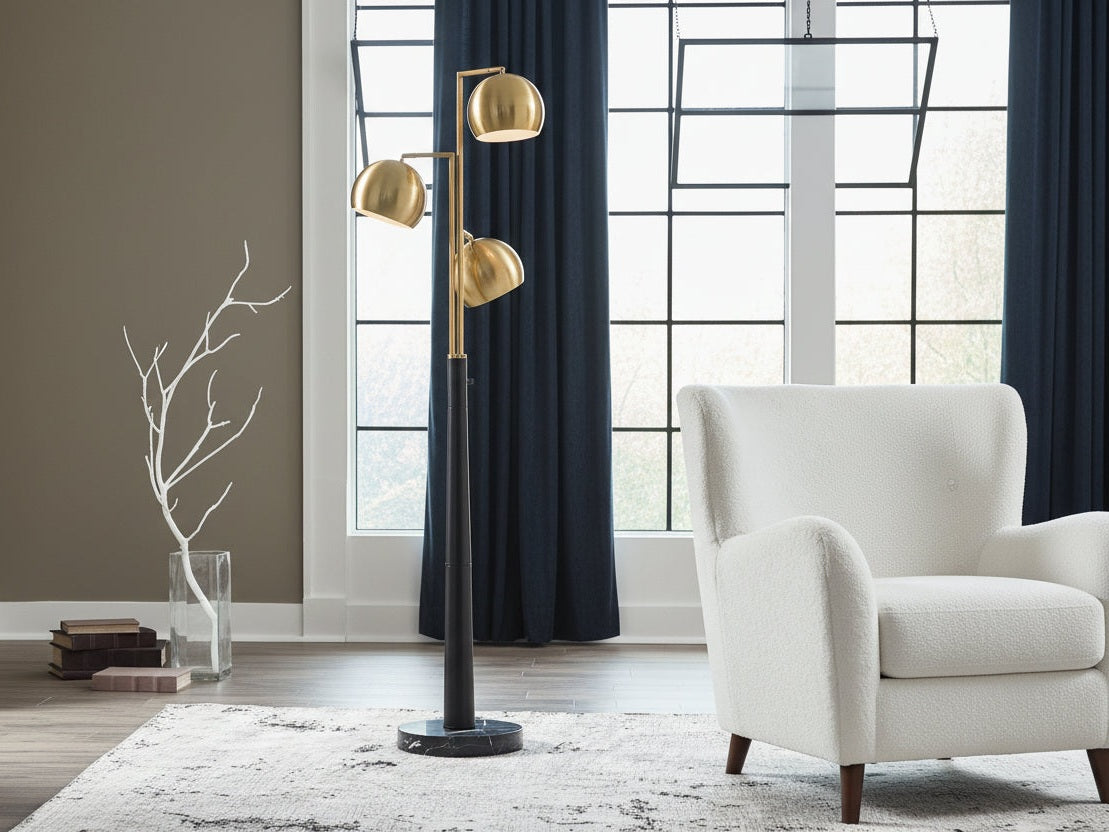The Sorcha modern floor lamp with gold accents in a living room setting.
