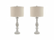 Two Bernadate table lamps with decorative bases and beige lampshades on a white background.