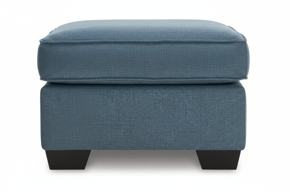 Blue upholstered ottoman on a white background