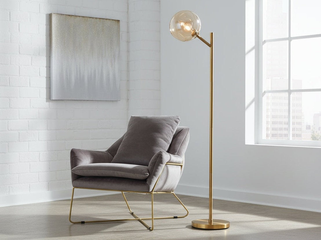 Modern living room with a brown armchair and floor lamp with brass base.