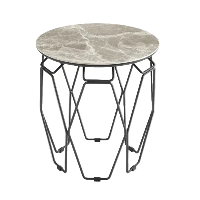 A modern side table showcases a round, grey veined marble top resting on a minimalist black geometric metal base.