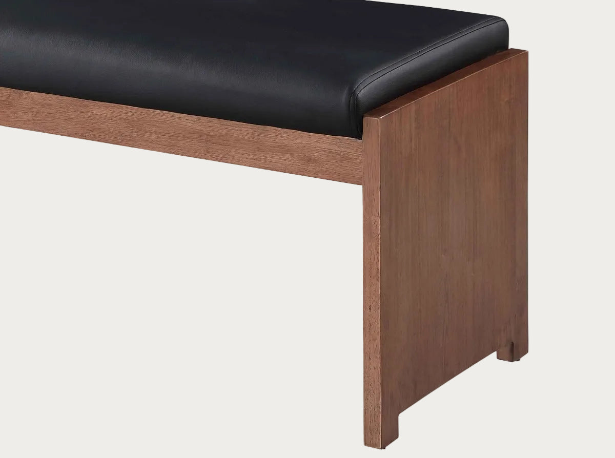 Wooden bench with black cushion on a white background