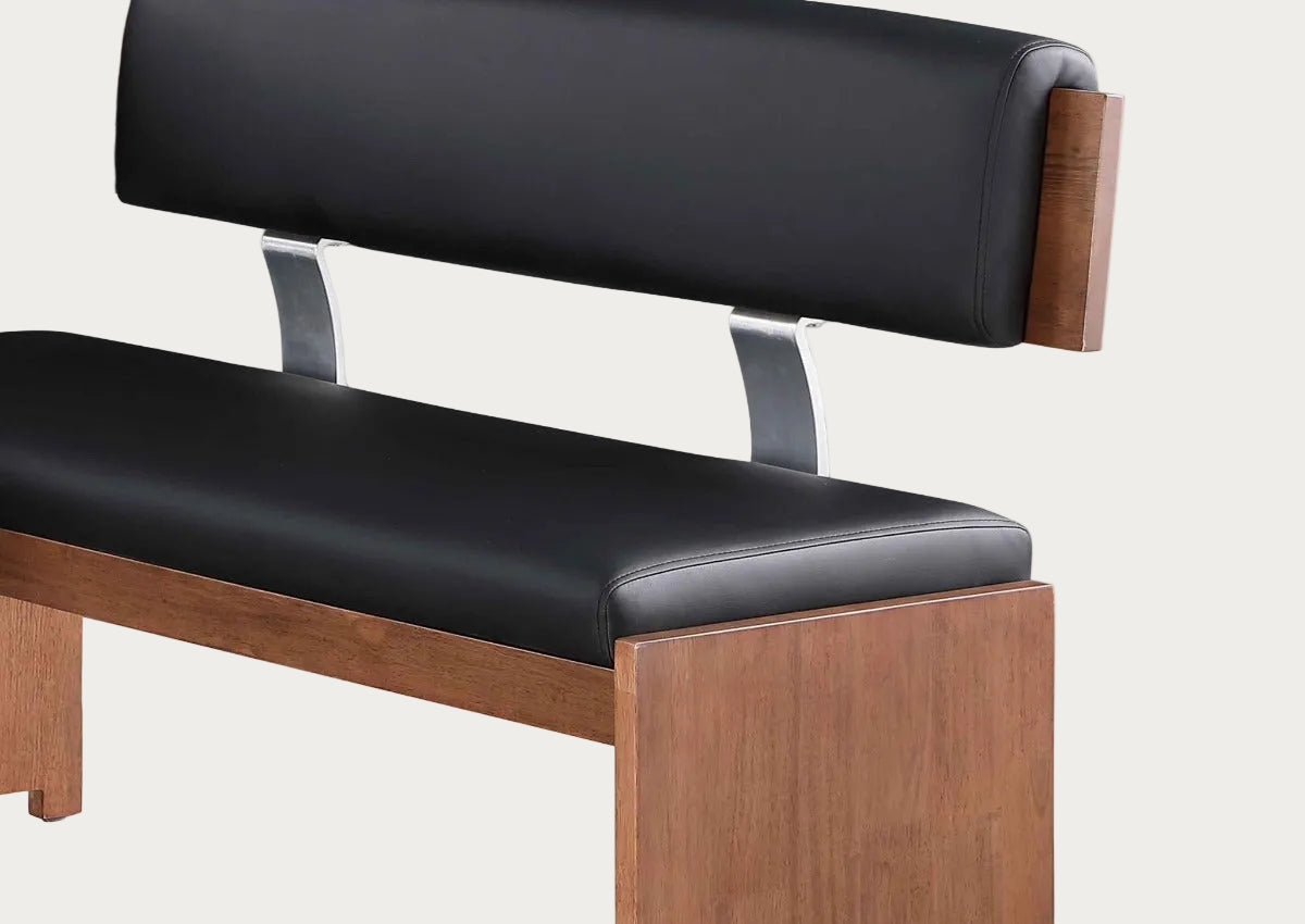 Black cushioned bench with wooden frame on a white background