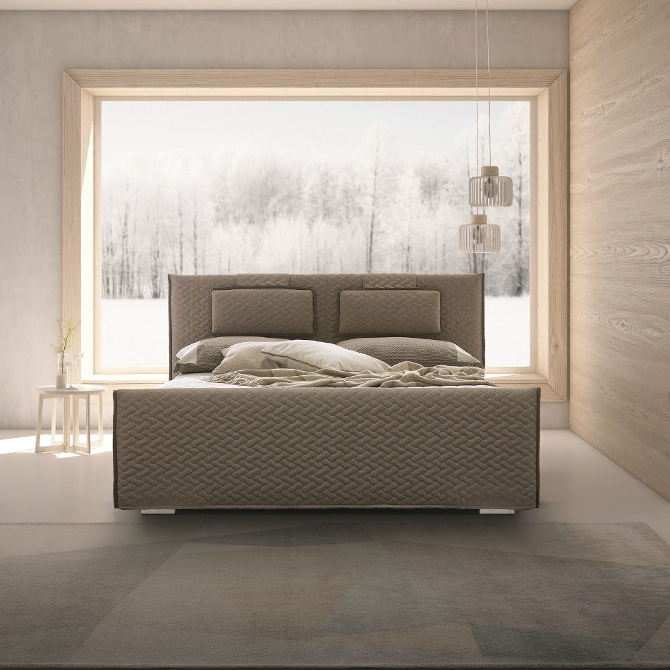 Modern bedroom with a textured bed and large window