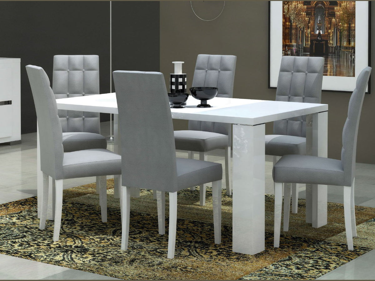 A modern 5-piece dining set featuring a glossy white rectangular table and six gray upholstered chairs with white legs, set on a patterned area rug in a dining room.