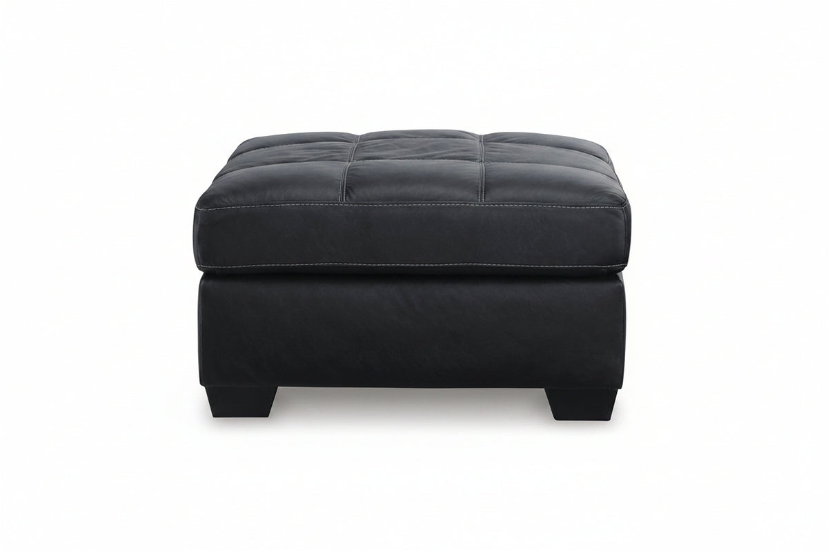 Black leather ottoman on a white background