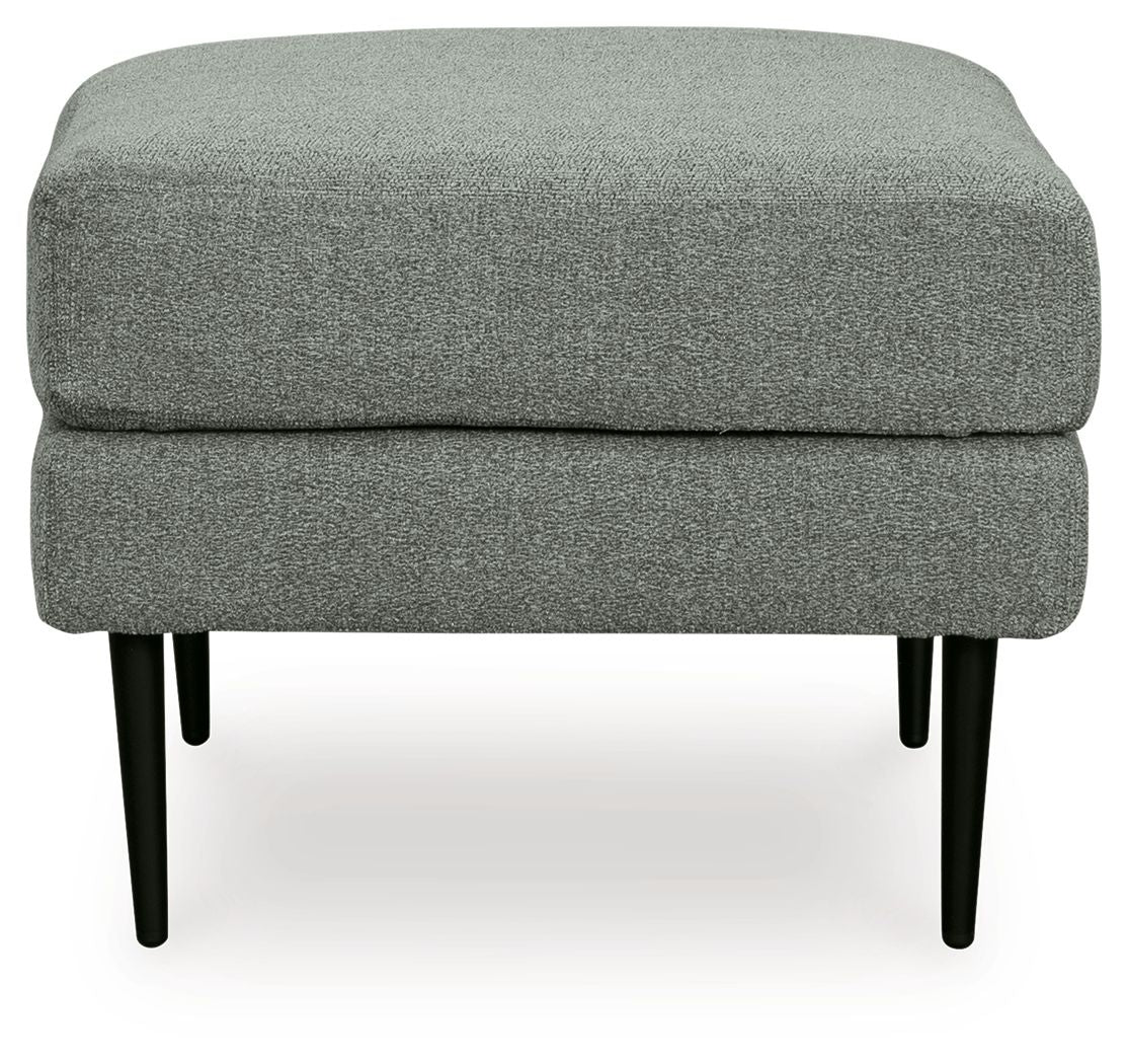 Gray upholstered ottoman with black legs on a white background