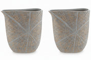 Two decorative vases with a textured pattern on a white background