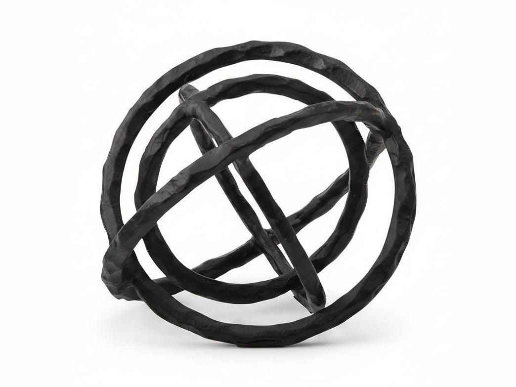 Black metal sphere sculpture on a white background