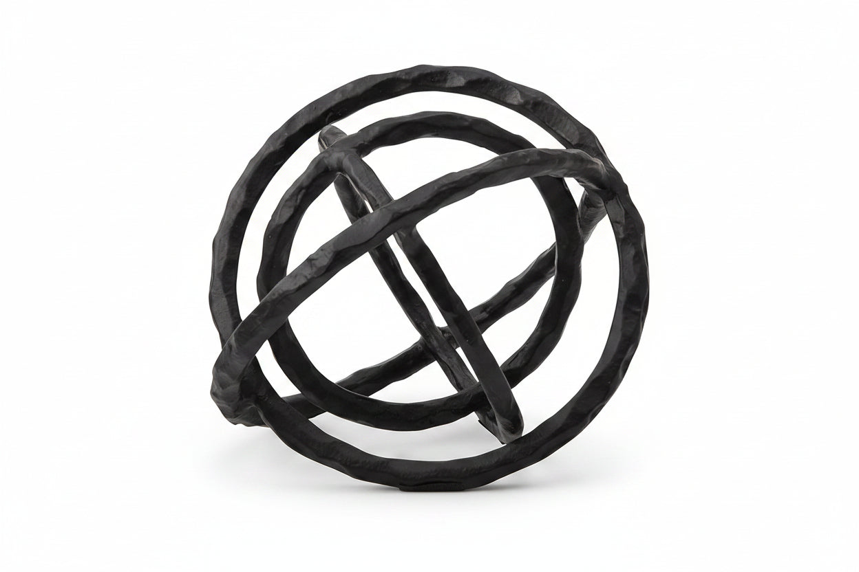 Black metal sphere sculpture on a white background