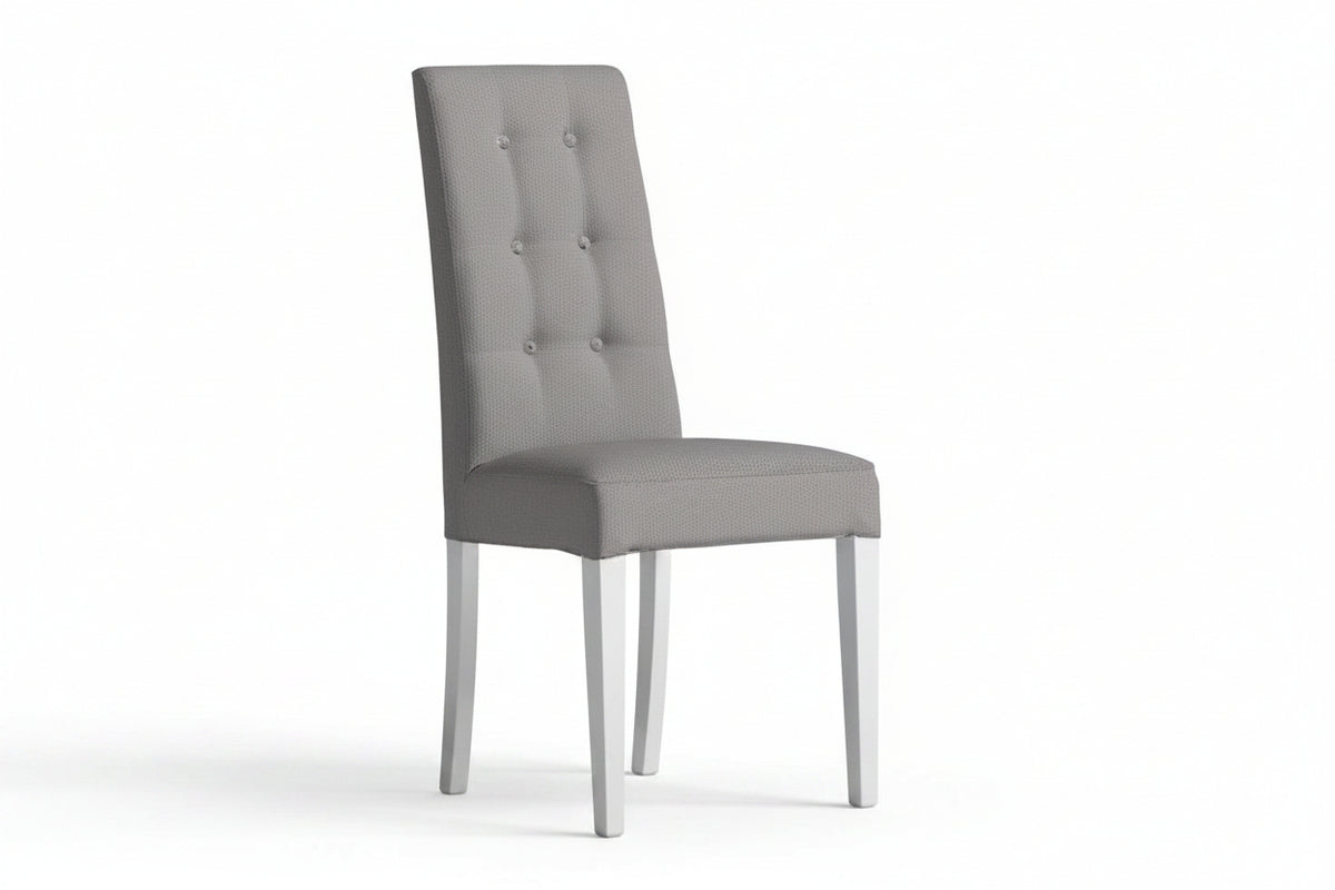 A single upholstered dining chair in light gray fabric with a tall button-tufted backrest and slim white legs, shown on a plain white background.