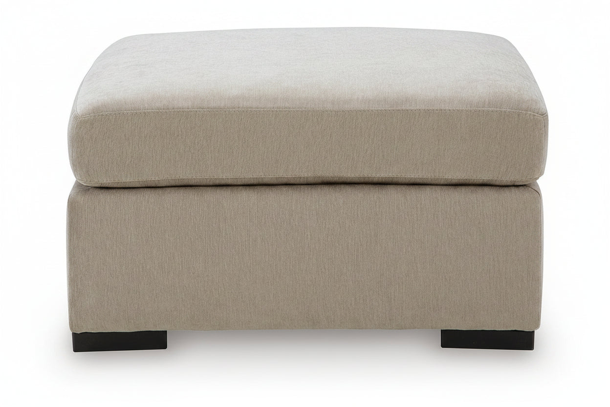 A square upholstered ottoman with a thick cushioned top and a lower storage base, upholstered in a textured light beige fabric with dark wooden feet, shown against a plain white background.