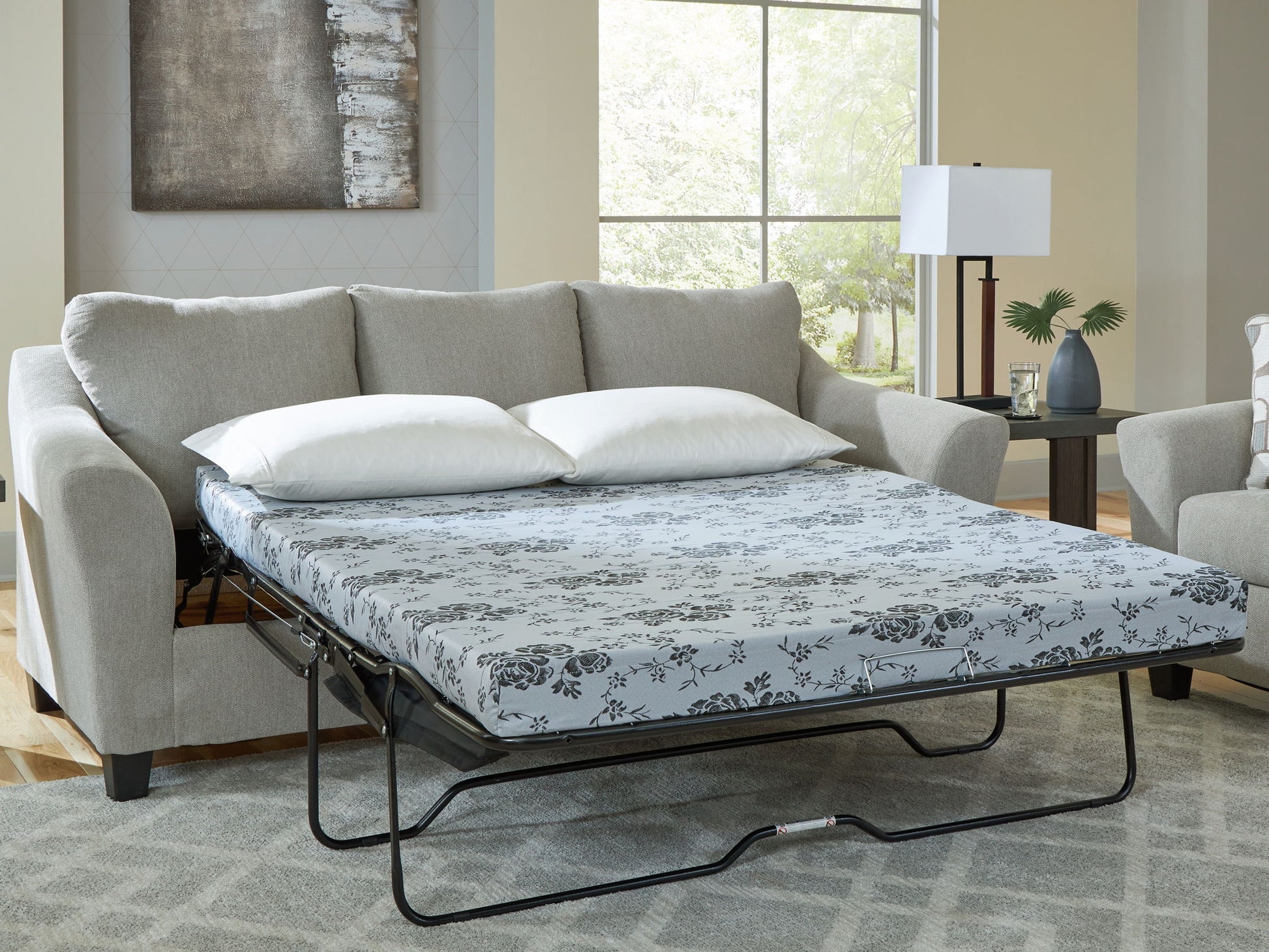 Sofa bed in a living room setting with floral mattress cover