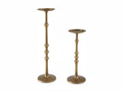 Two brass candle holders on a white background