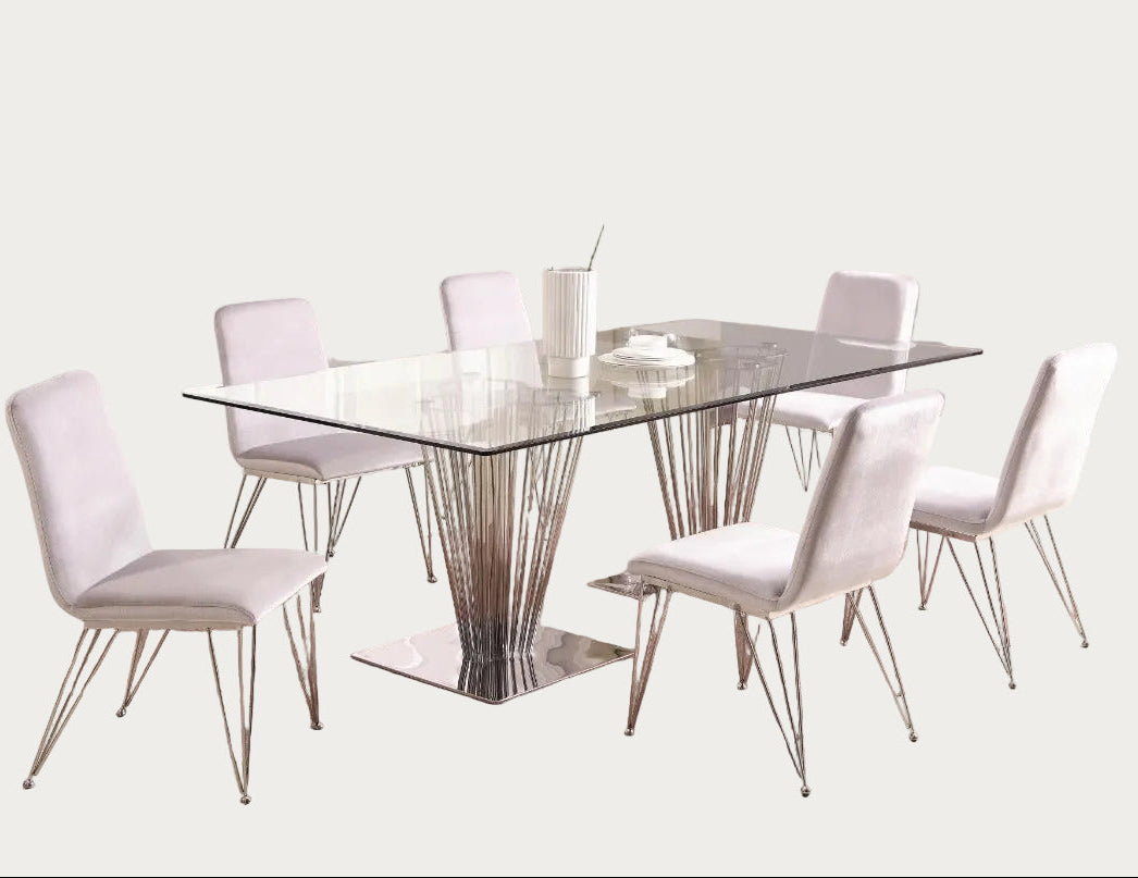 The Fernanda modern dining room has a glass table and white chairs on a wooden rug.