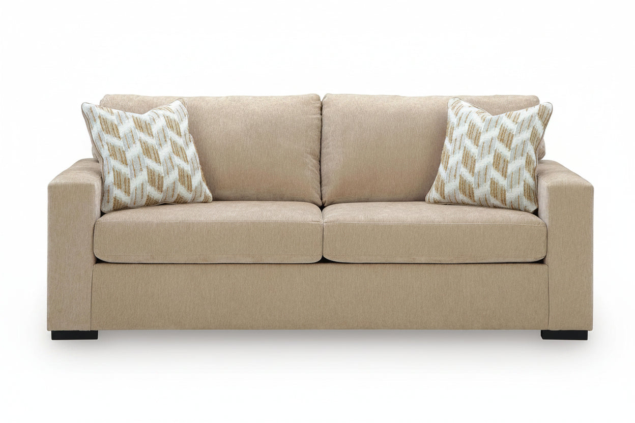 Beige sofa with patterned pillows on a white background