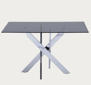 Genevieve dining able with a glass top and metal frame on a white background