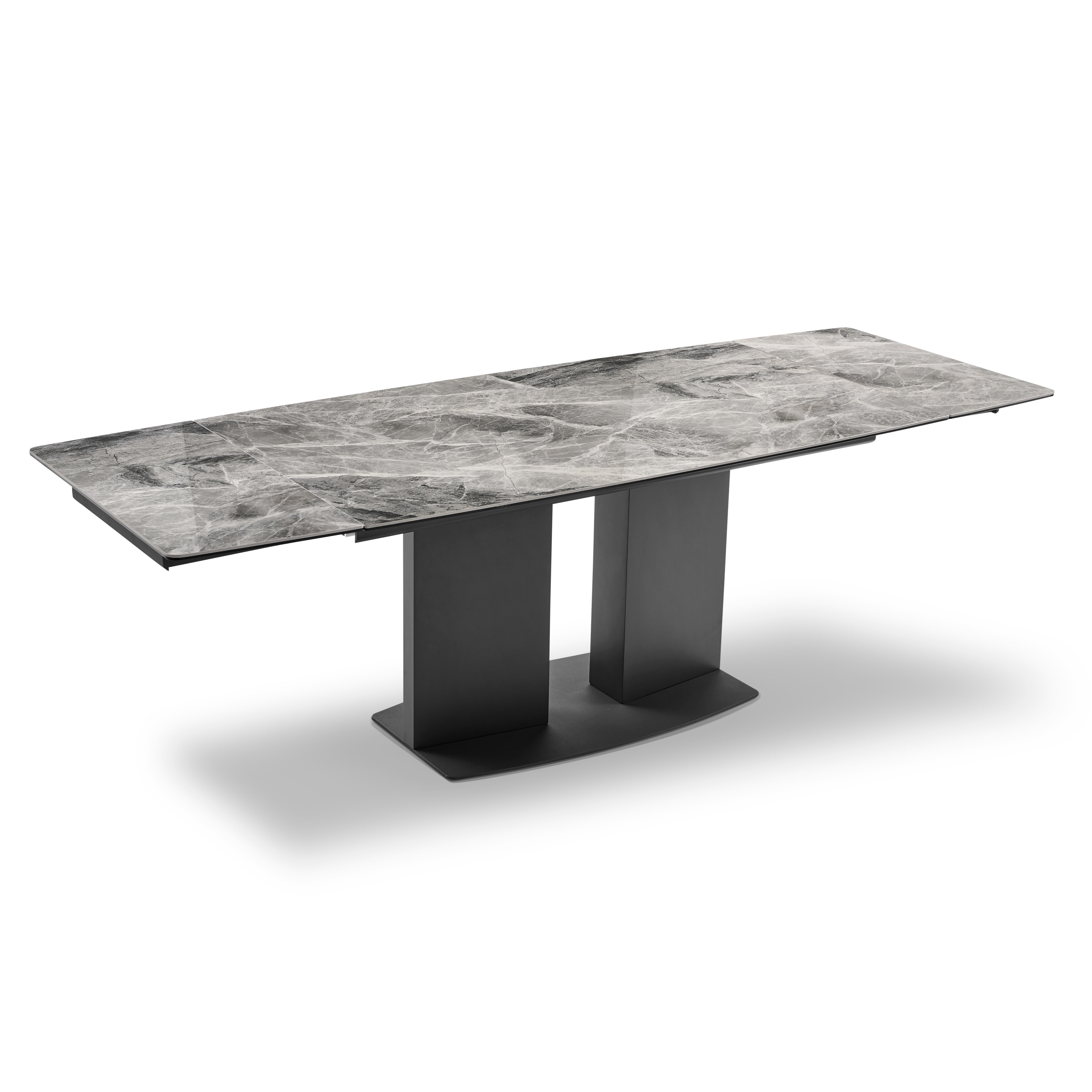 Grand extendable dining table with marble-like top and black legs on a white background.