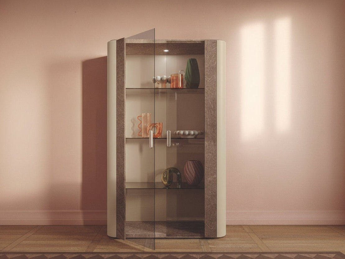 Tall glass display cabinet with decorative items against a neutral wall.