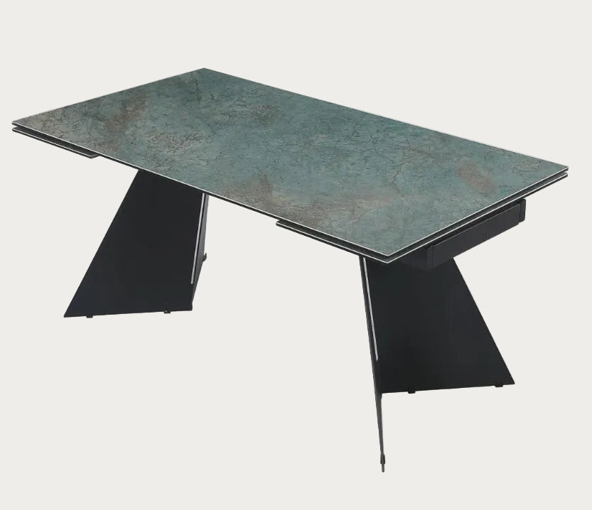Helen is a modern dining table with a greenish-brown ceramic top and black metal legs.