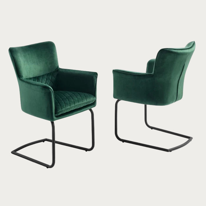 Loran armchair upholstered in green velvet fabric with black legs