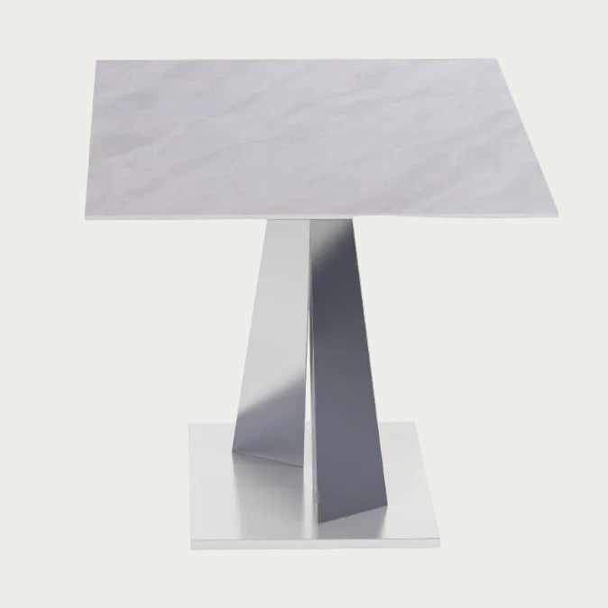 Modern side table with a quilted top and geometric base on a white background