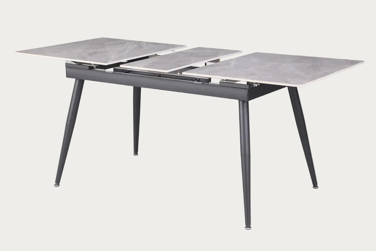 Judith dining table with marble-like top and metal legs.