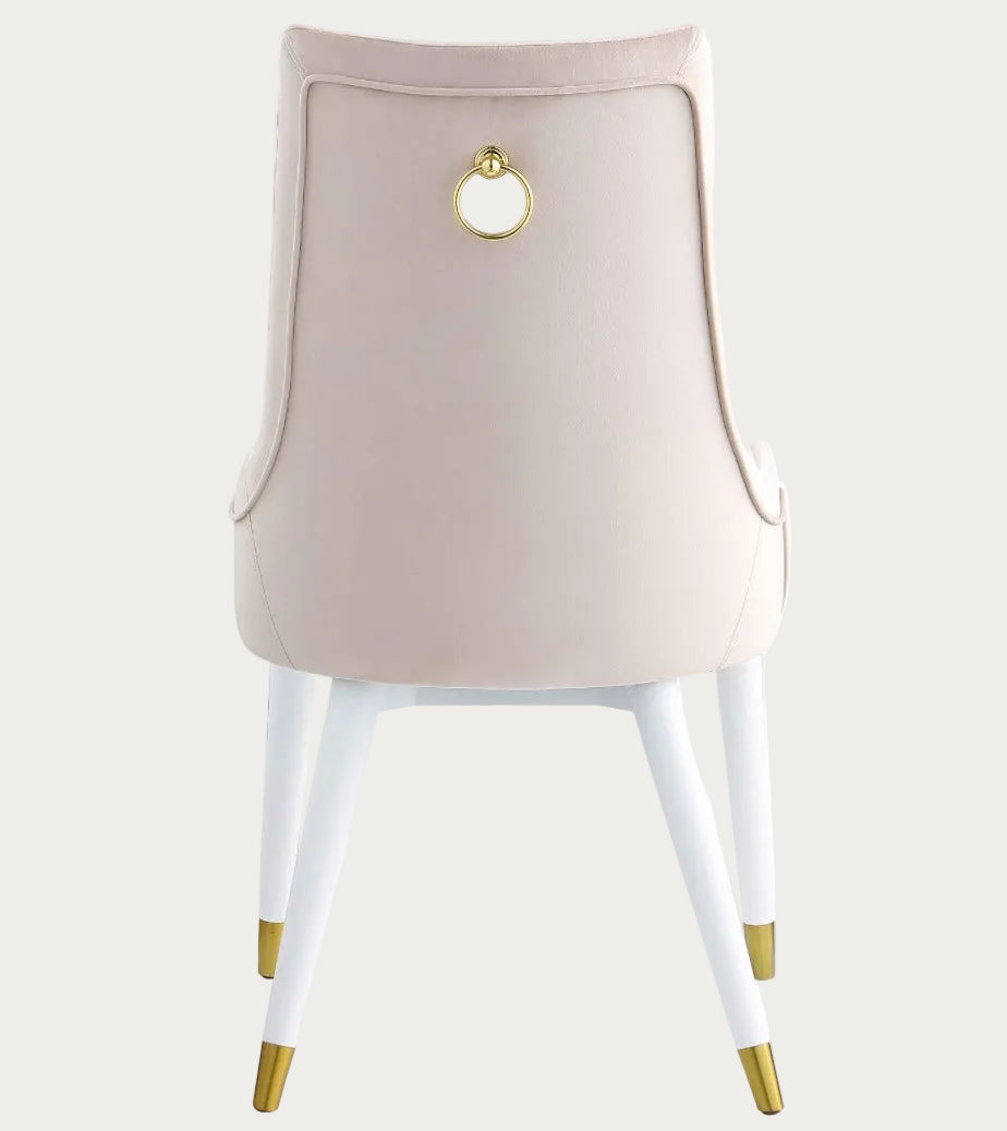 Chair with beige backrest, gold ring, and white legs with gold accents on a white background