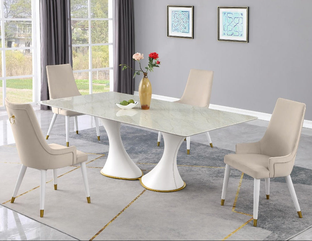 Judy dining room with a marble table and beige chairs in a well-lit room.