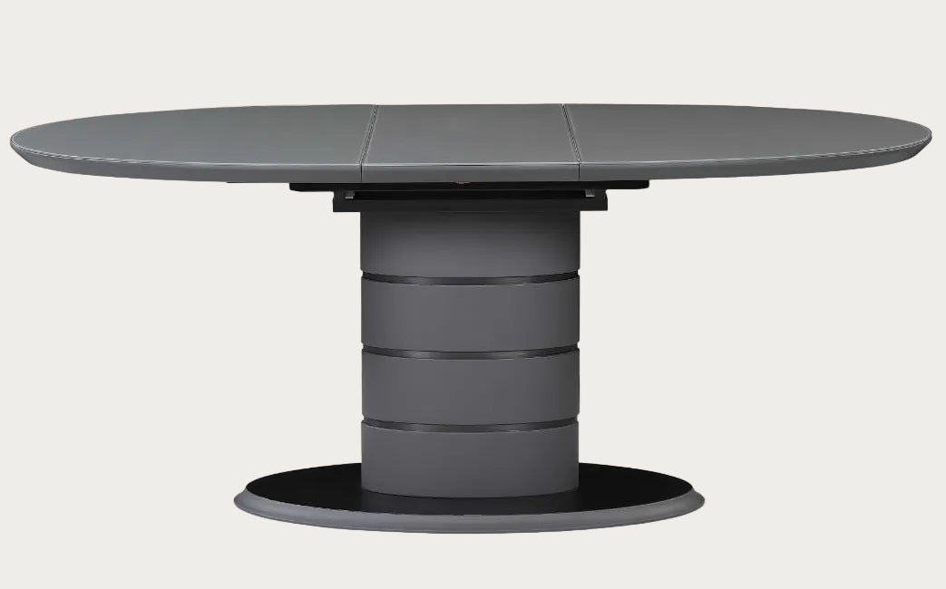 Gray round table with a unique cylindrical base on a white background