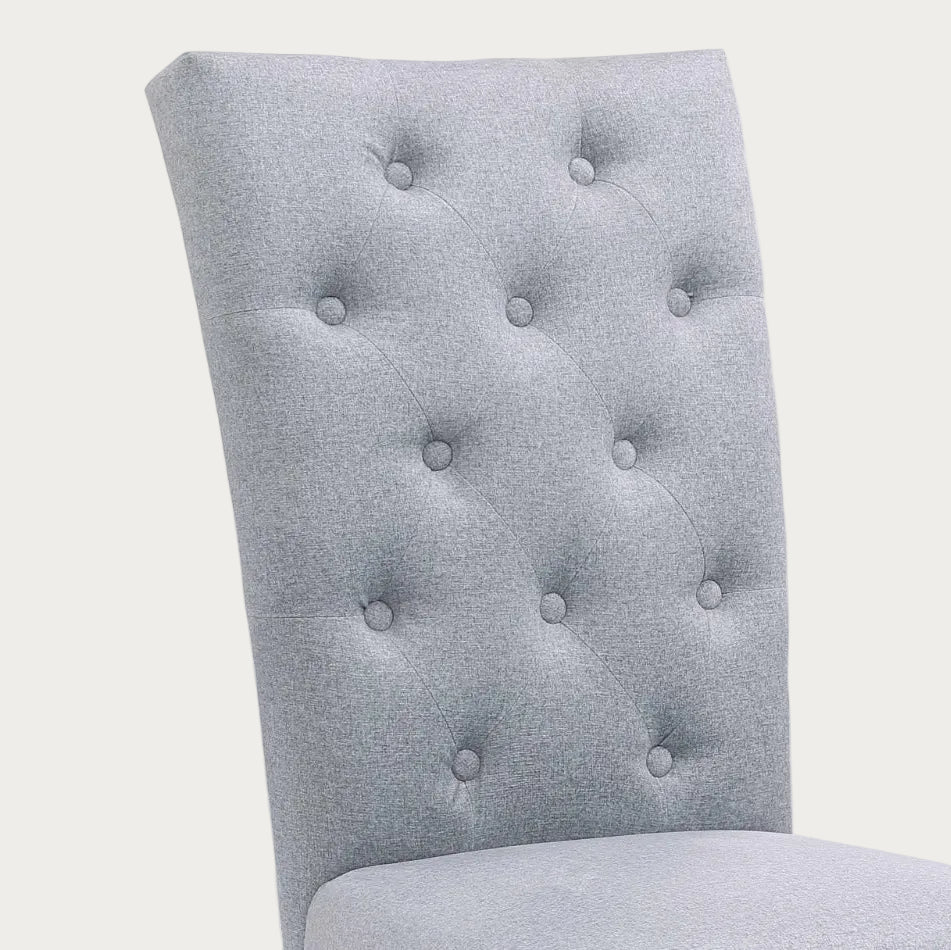 Jennifer gray fabric upholstered chair with tufted backrest.