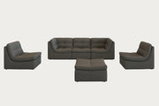 The Lego modern living room with a gray sectional sofa, armchair, and ottoman on a patterned rug.