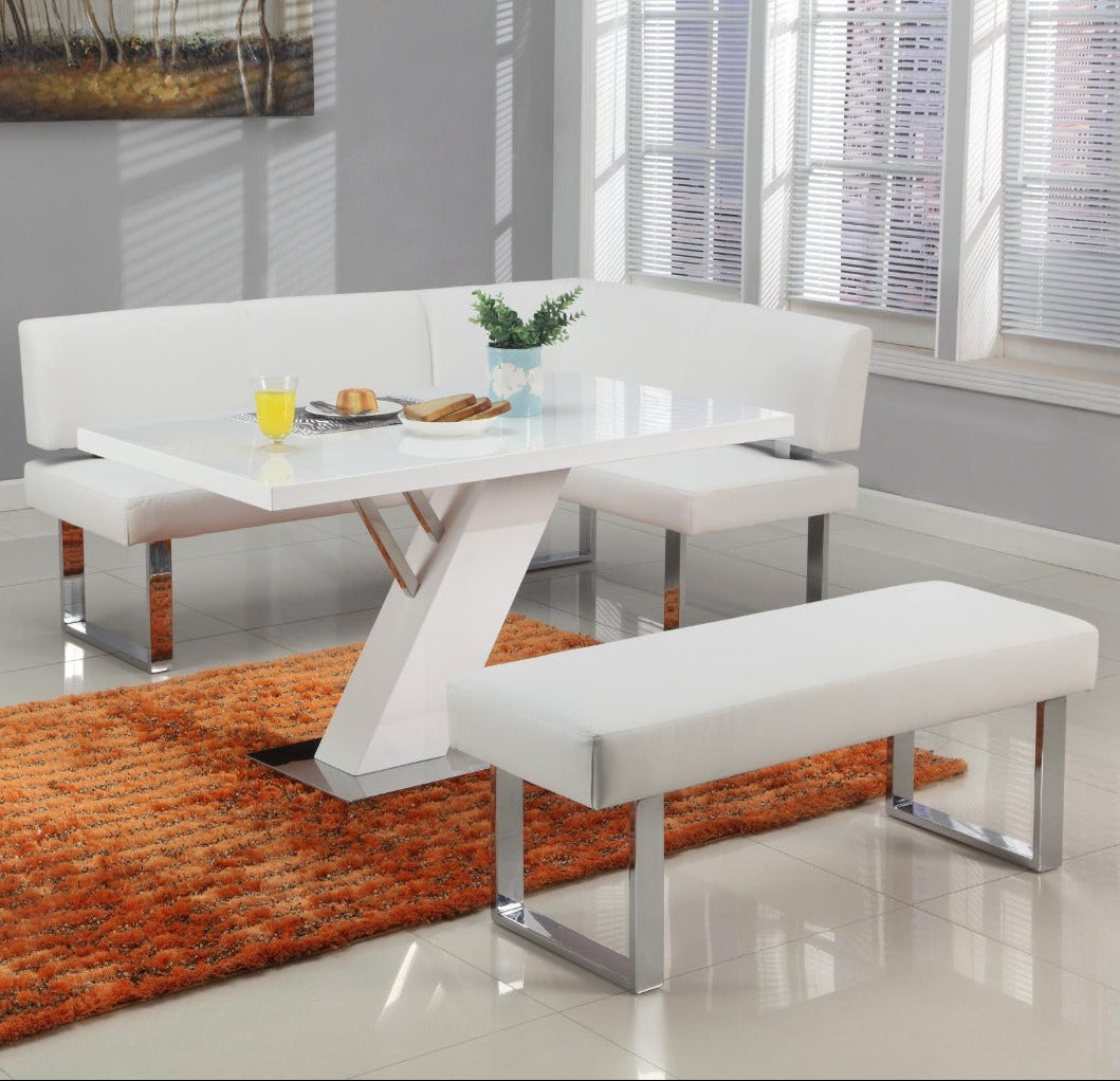Linden modern white dining set with benches in a room with a gray wall and orange rug.