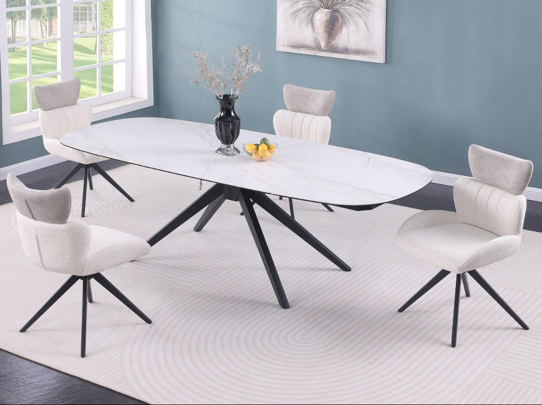 Dining room with a modern oval table and chairs in a well-lit room.