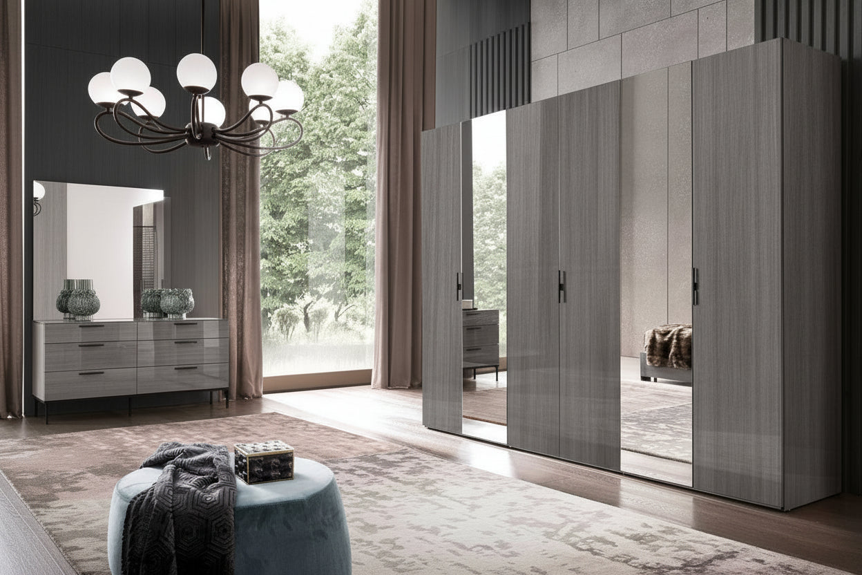Modern bedroom with a large mirrored Novecento wardrobe and a chandelier.