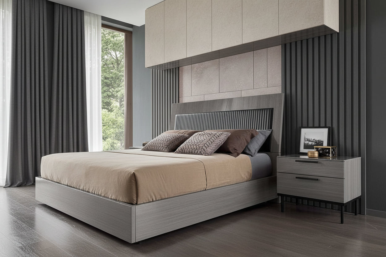 Novecento modern bedroom with a bed and nightstand featuring decorative pillows and a small table.