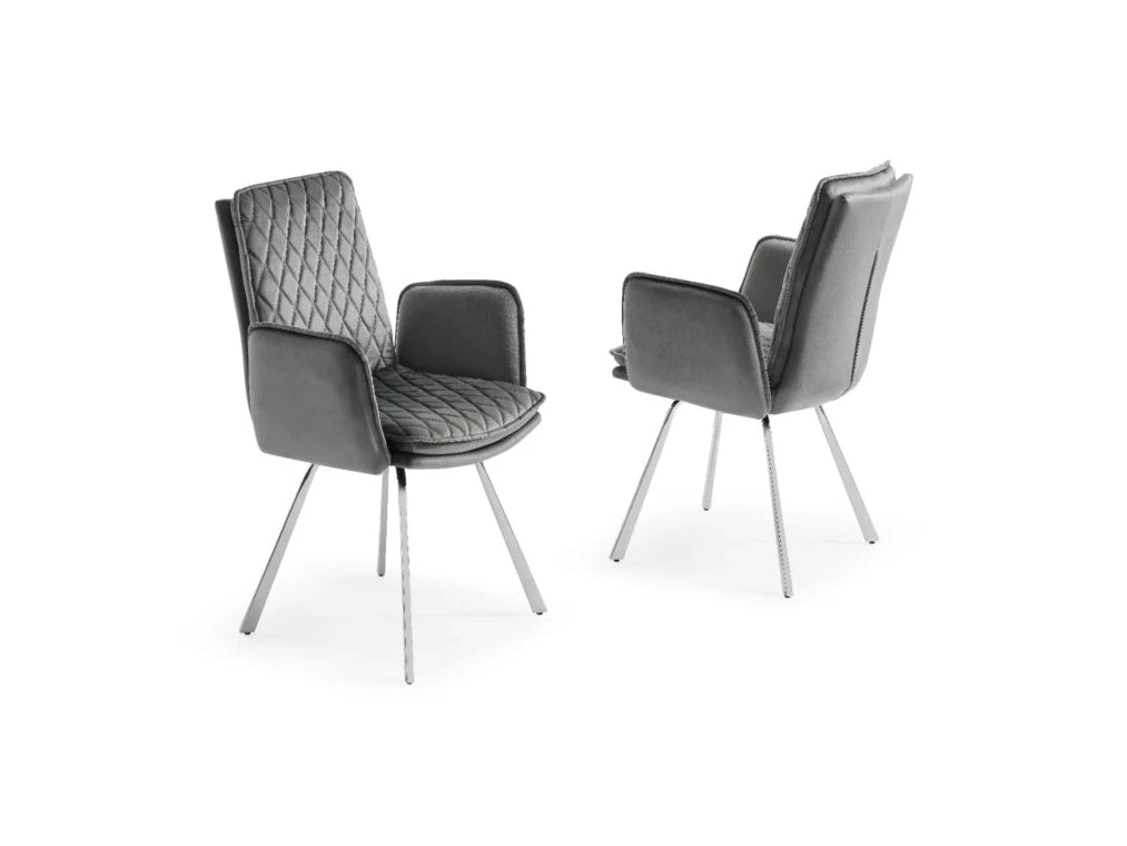 Two modern grey velvet dining chairs showcase elegant diamond-quilted upholstery and slim chrome legs against a white background.